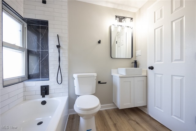 full bathroom featuring vanity, shower with separate bathtub, hardwood / wood-style flooring, and toilet