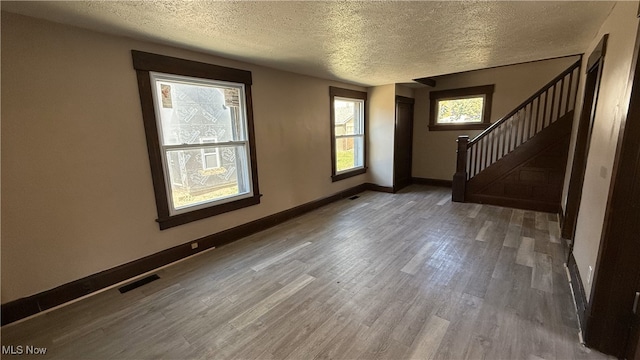 interior space featuring hardwood / wood-style floors and a textured ceiling