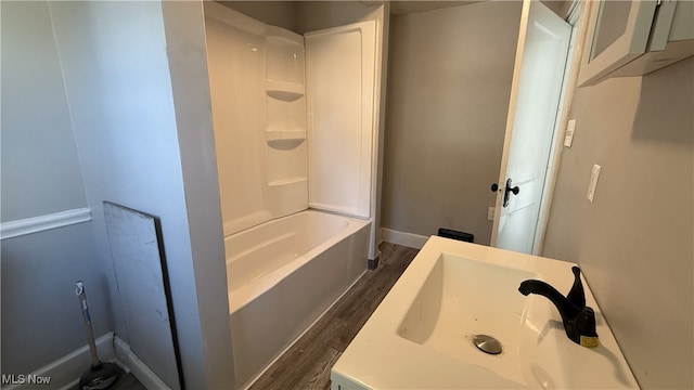 bathroom with vanity, hardwood / wood-style floors, and shower / bathtub combination