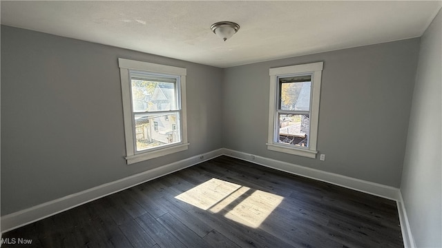 empty room featuring dark wood-type flooring