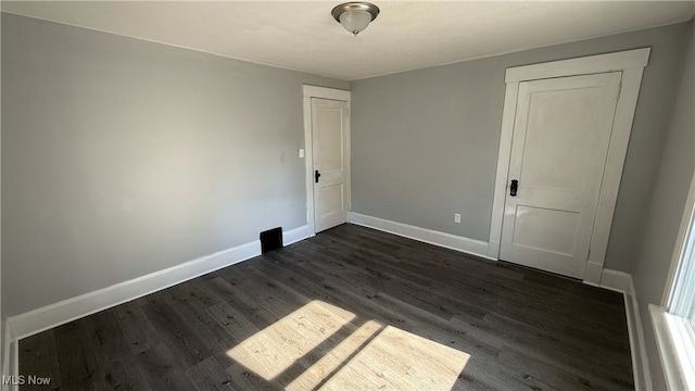 empty room featuring dark wood-type flooring