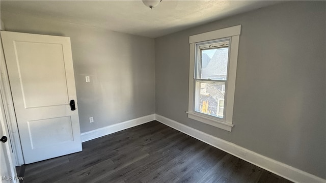 unfurnished room with dark hardwood / wood-style floors