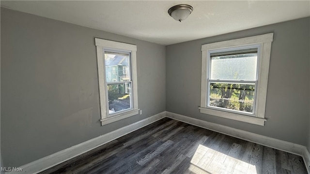 spare room with dark wood-type flooring