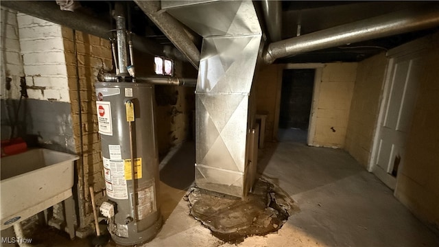 utility room featuring sink, heating unit, and gas water heater