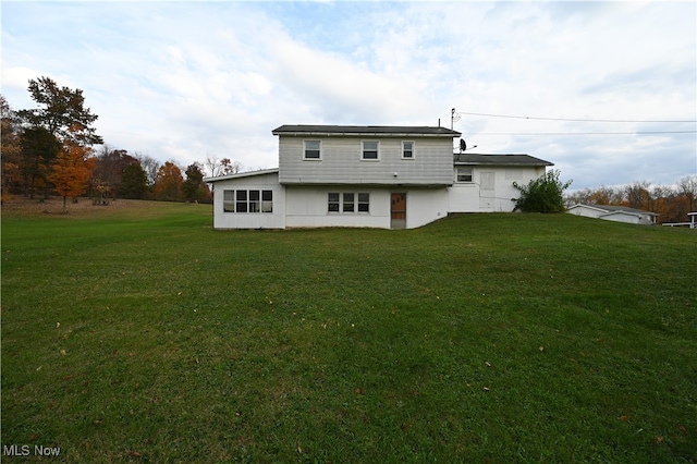 back of property featuring a yard