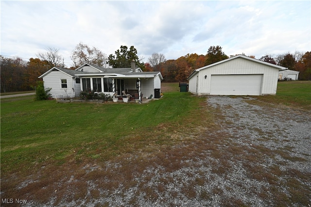 view of front of home featuring a front yard, covered porch, and a garage