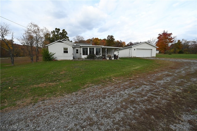 ranch-style house with a front yard, an outbuilding, and a garage