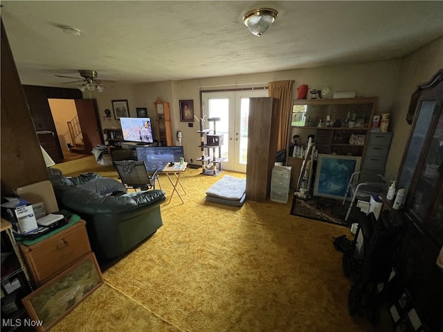 living room featuring french doors, carpet flooring, and ceiling fan