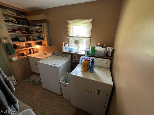 laundry room with cabinets and washing machine and clothes dryer