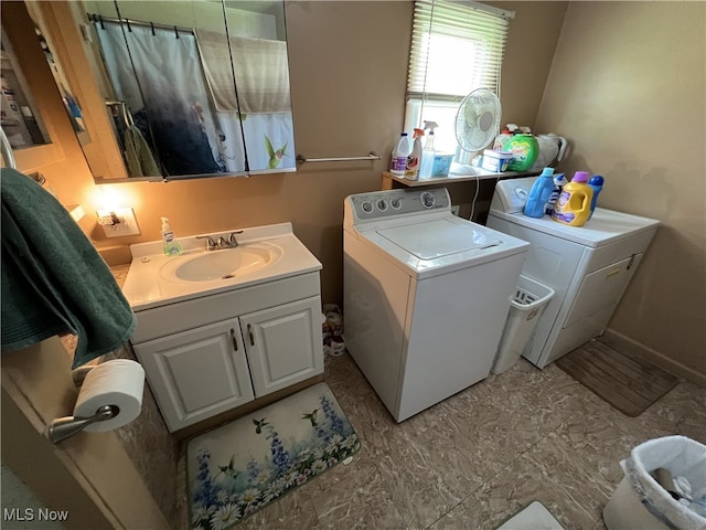 washroom featuring washer and dryer and sink