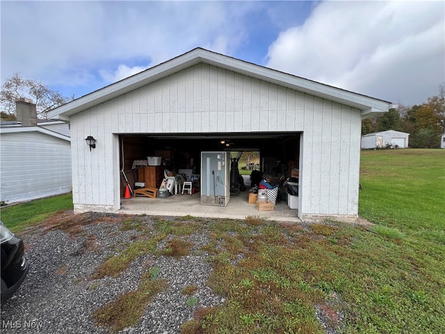 garage featuring a lawn