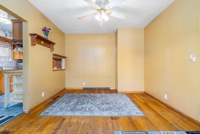 spare room featuring light hardwood / wood-style floors and ceiling fan