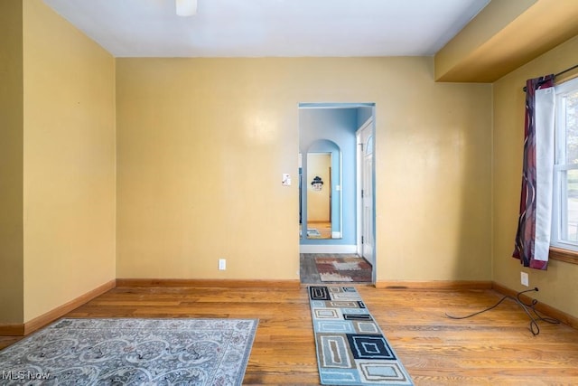 unfurnished room with hardwood / wood-style flooring