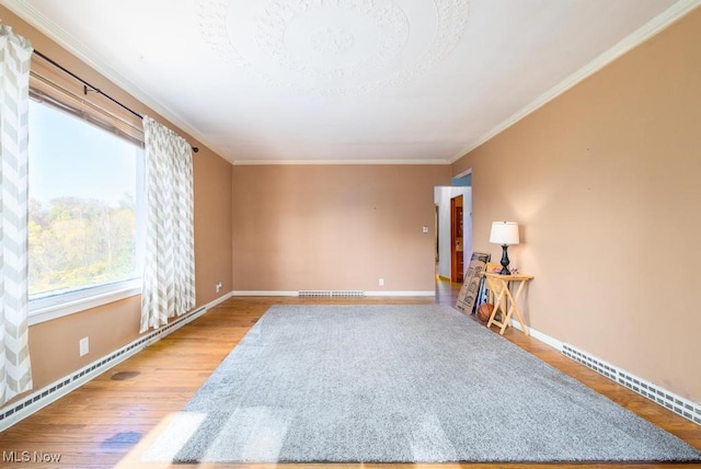 spare room featuring crown molding and hardwood / wood-style flooring