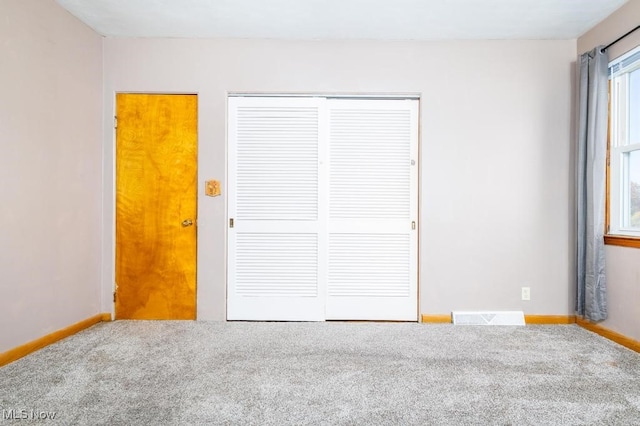 unfurnished bedroom featuring a closet and carpet floors