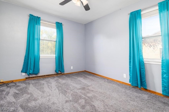 empty room featuring carpet floors, baseboard heating, and ceiling fan