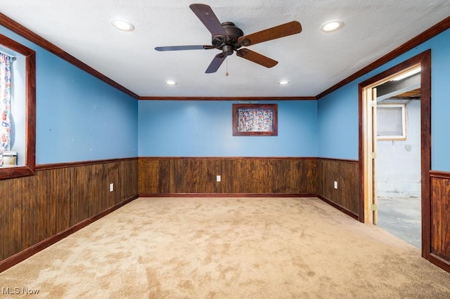 empty room with light carpet and wood walls