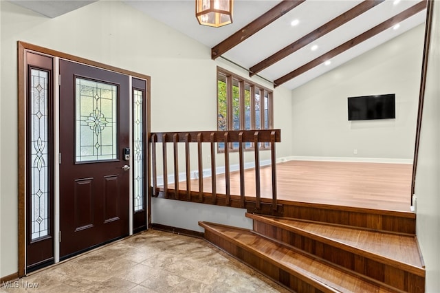 entrance foyer featuring lofted ceiling with beams