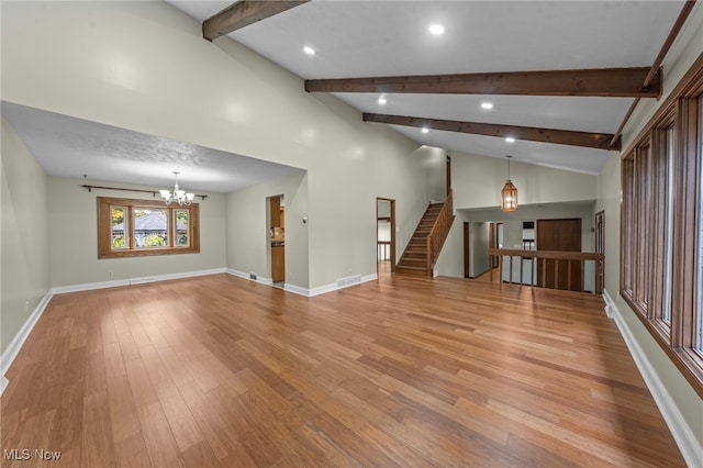 unfurnished living room with light hardwood / wood-style floors, high vaulted ceiling, beam ceiling, and a chandelier