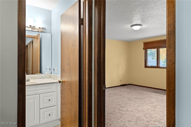 bathroom with vanity and a textured ceiling