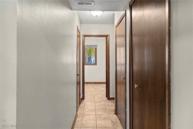 hallway featuring a textured ceiling