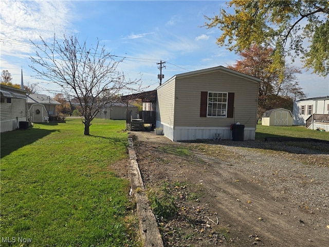 view of home's exterior featuring a yard, a shed, and central air condition unit