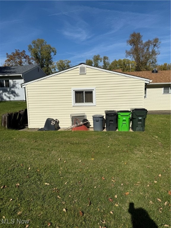 view of outbuilding with a yard