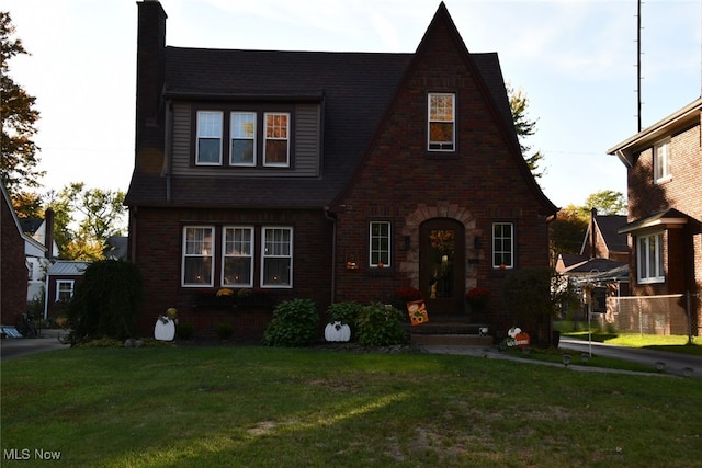 tudor home featuring a front yard