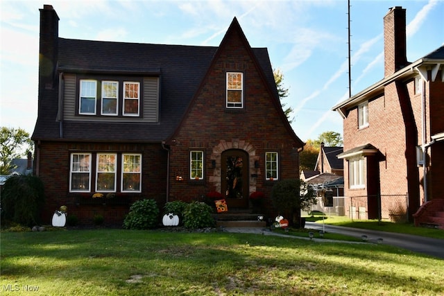 tudor home featuring a front yard