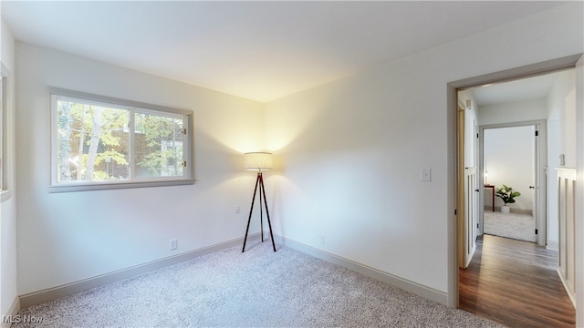 unfurnished room with wood-type flooring