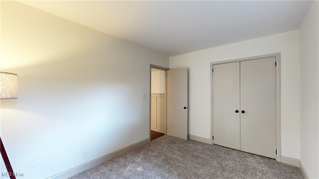 unfurnished bedroom with a closet and light carpet