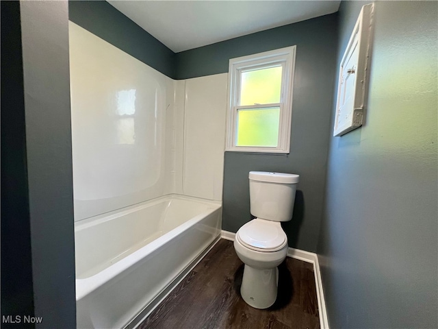 bathroom with shower / tub combination, wood-type flooring, and toilet