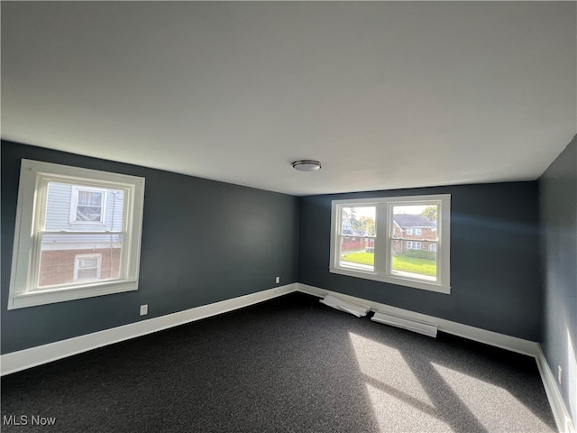 unfurnished room featuring lofted ceiling and carpet flooring