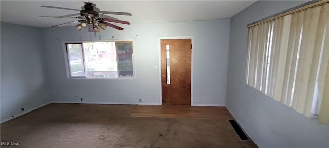 empty room featuring dark carpet and ceiling fan