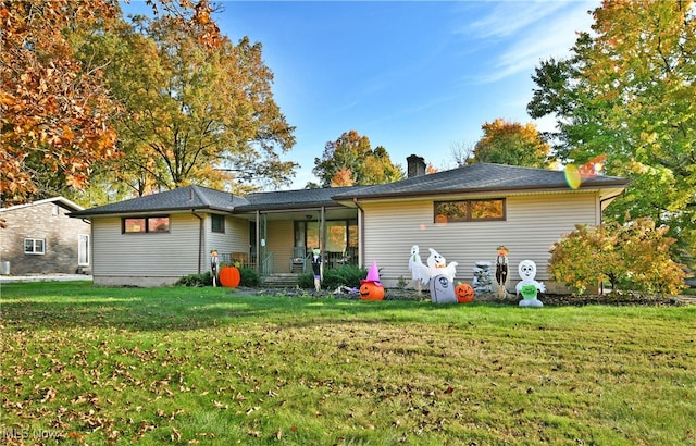 rear view of house with a yard