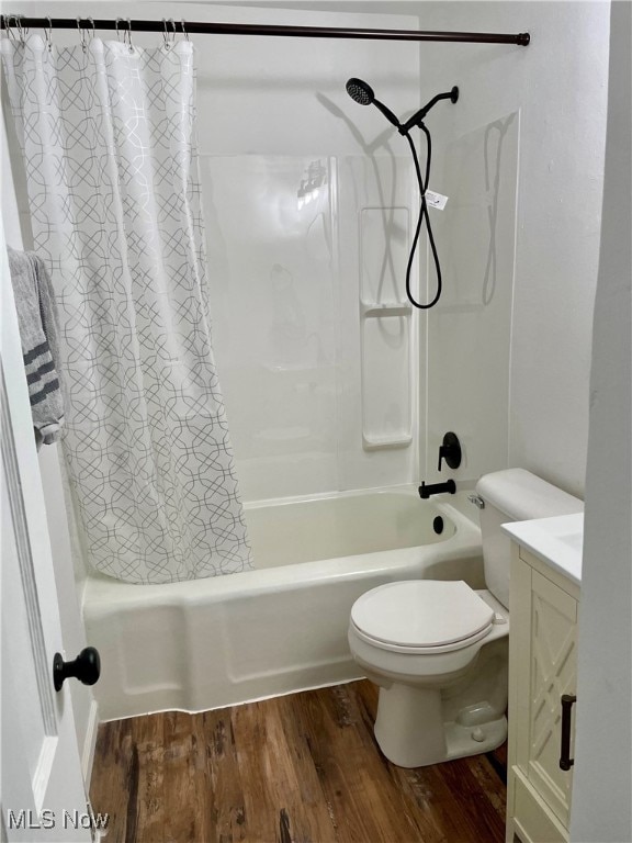 full bathroom with vanity, hardwood / wood-style floors, toilet, and shower / bathtub combination with curtain