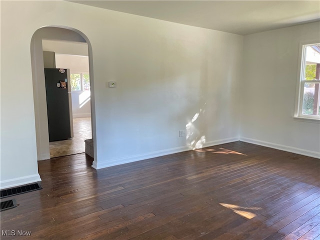 unfurnished room featuring dark hardwood / wood-style floors