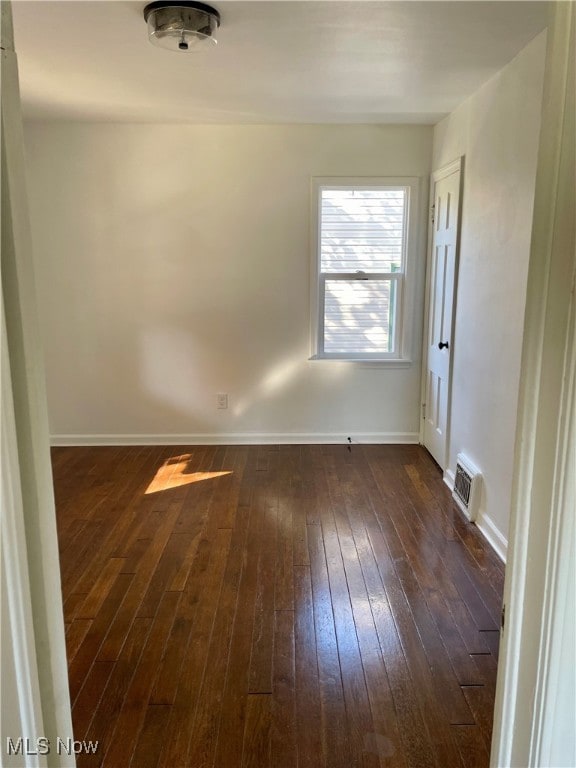 empty room featuring dark wood-type flooring