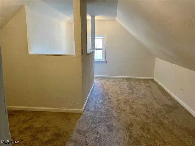 bonus room featuring lofted ceiling and carpet flooring