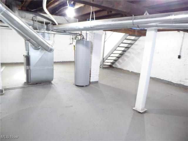 basement featuring water heater and heating unit