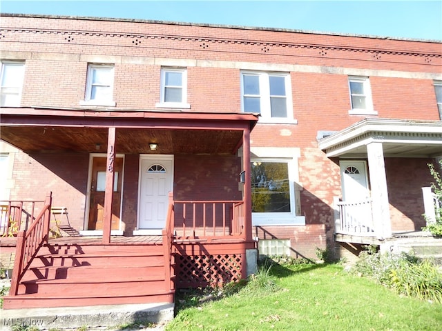 rear view of house featuring a porch