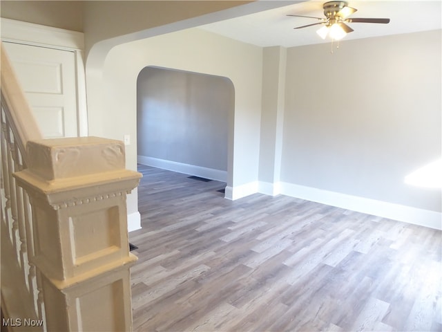 spare room featuring wood-type flooring and ceiling fan