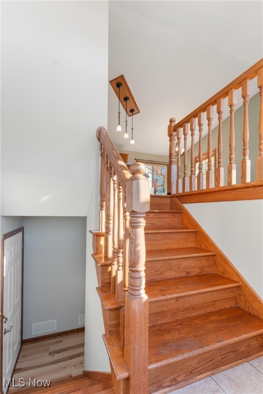 stairs featuring wood-type flooring