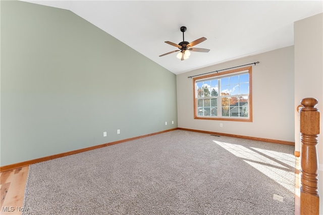 carpeted spare room with lofted ceiling and ceiling fan