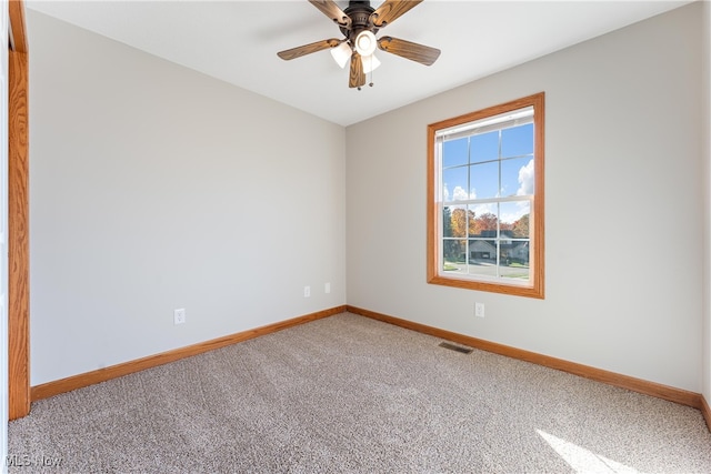 empty room featuring ceiling fan and carpet floors