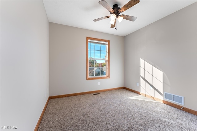 spare room with ceiling fan and carpet