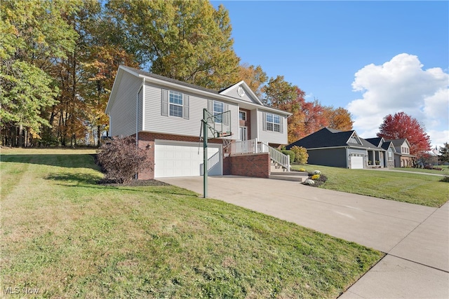 bi-level home featuring a garage and a front lawn