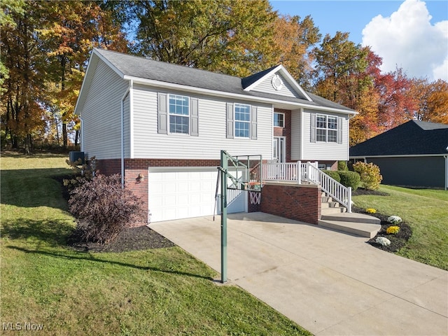 split foyer home featuring a front yard, central AC, and a garage