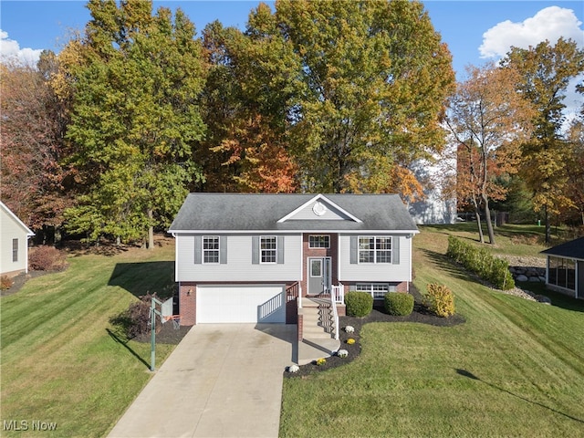 split foyer home with a front yard and a garage