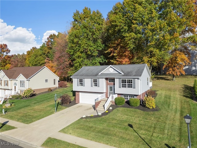 split foyer home featuring a garage and a front lawn